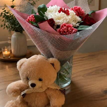 A cute teddy bear with a fresh floral bouquet from a professional gift delivery Lahore service.