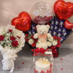Luxury chocolate bouquet Lahore featuring 15 chocolate bars, imported red flowers, and a pineapple cake.