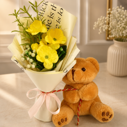 A cute teddy bear holding a yellow flower bouquet for gift delivery Lahore.