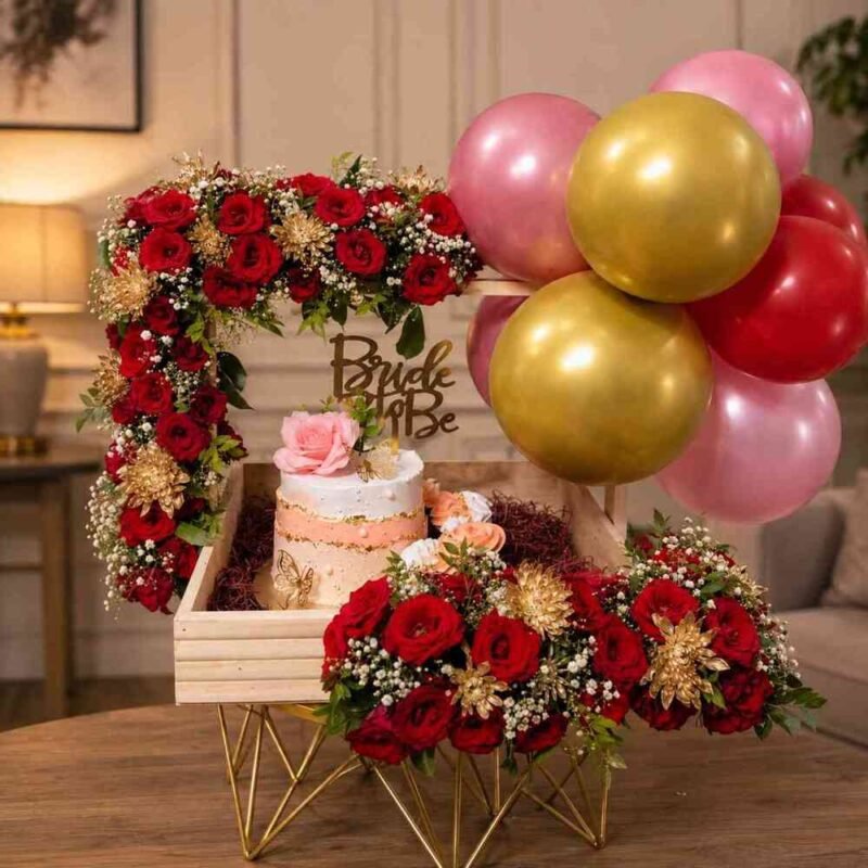 Exquisite bridal shower gifts featuring a cake, roses, and balloons.