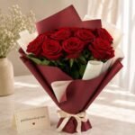 Crimson roses in maroon wrapping florist near me Lahore