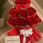 Grand three-tier red rose tower arranged for flower delivery services Lahore
