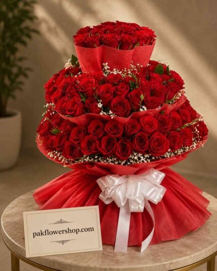 Grand three-tier red rose tower arranged for flower delivery services Lahore