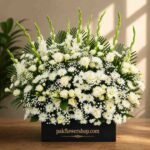 Elegant white sympathy floral arrangement for funeral flowers delivery Lahore