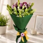 Flower bouquet Lahore with green wrapping and purple white flowers