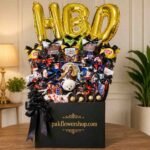 birthday gift hamper with chocolates and HBD balloons