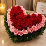 Elegant heart flower arrangement Pakistan with fresh red and pink roses and decorative greenery.
