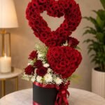 Rose Arrangement Lahore with fresh red roses in a heart-shaped stand.