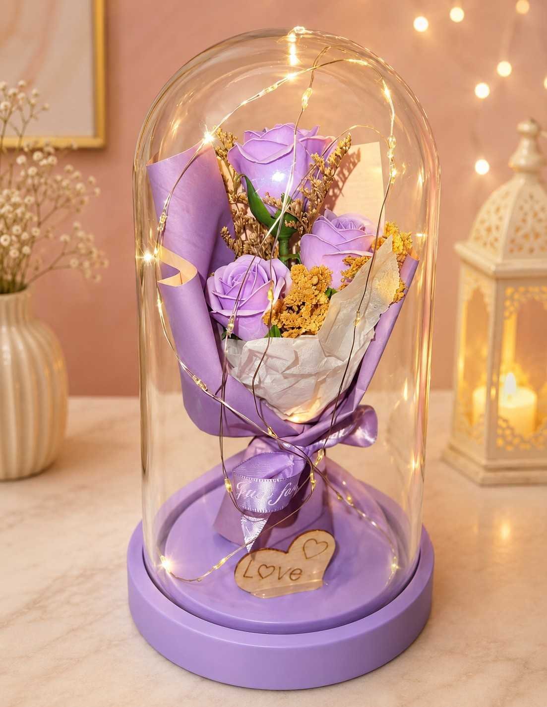 Glass Dome Flowers Pakistan Glass Dome Flowers Pakistan with lavender roses and warm LED lights.