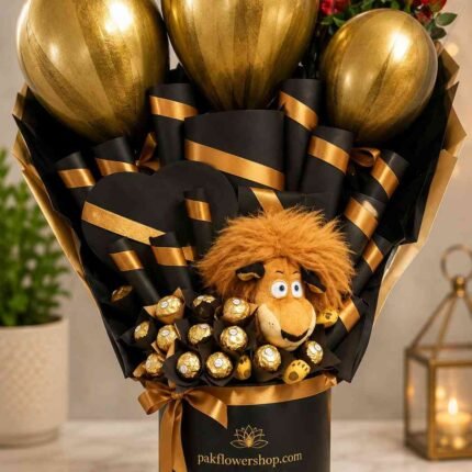 Elegant gift box Pakistan with premium chocolates, metallic balloons, plush toy, and decorative floral accents.