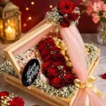 Elegant flower hamper Pakistan with fresh red roses, premium chocolates, and luxury decorative wrapping.