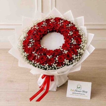 Fresh Funeral Flower Wreath made with red roses and white baby's breath