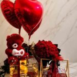 Elegant gift hamper Pakistan with red roses, heart balloons, chocolates, and teddy bear for special occasions.
