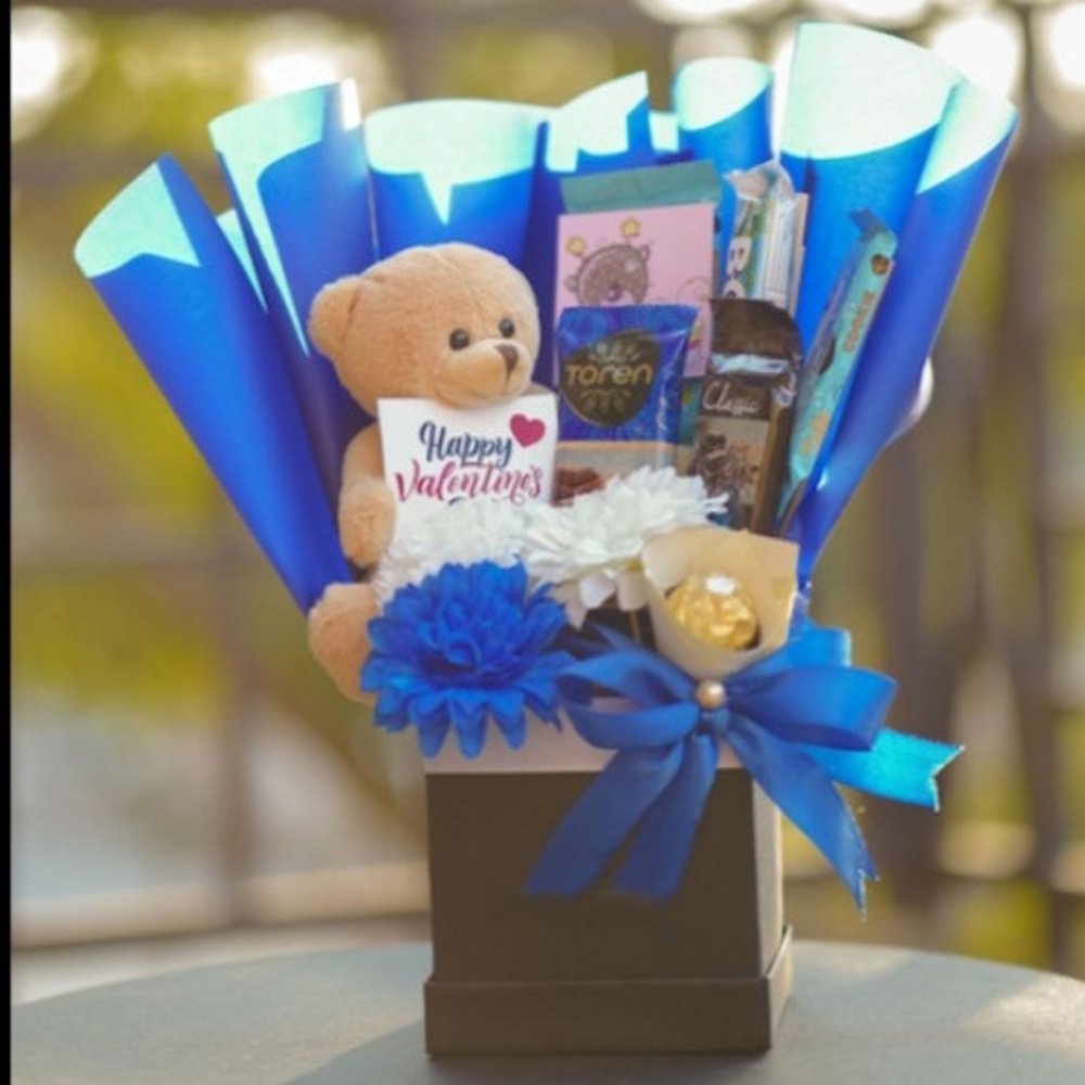 Elegant Blue Basket Hamper Premium gift basket Pakistan with chocolates, flowers, teddy bear, and elegant decorative packaging.