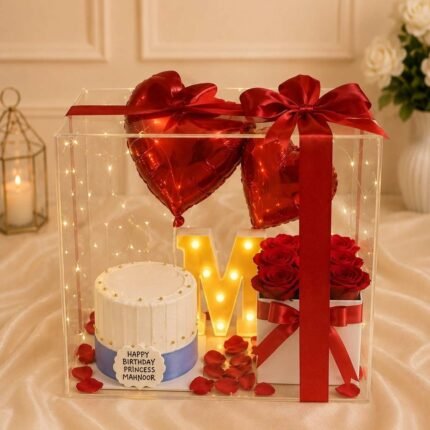 Clear acrylic box with a custom cake and balloons for flower delivery in Lahore