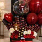 Luxury gift hamper Lahore with red roses, chocolates, balloons, and teddy bear
