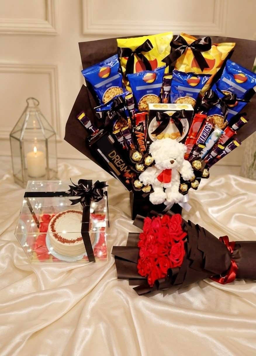 Grand Snack Hamper for Corporate Gift Delivery in Lahore Large snack bouquet, teddy bear, and cake box arranged for corporate gift delivery in Lahore