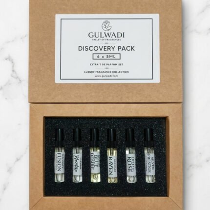 An open kraft gift box containing a Gulwadi Discovery Pack with six 5ML extrait de parfum tester vials on a marble surface