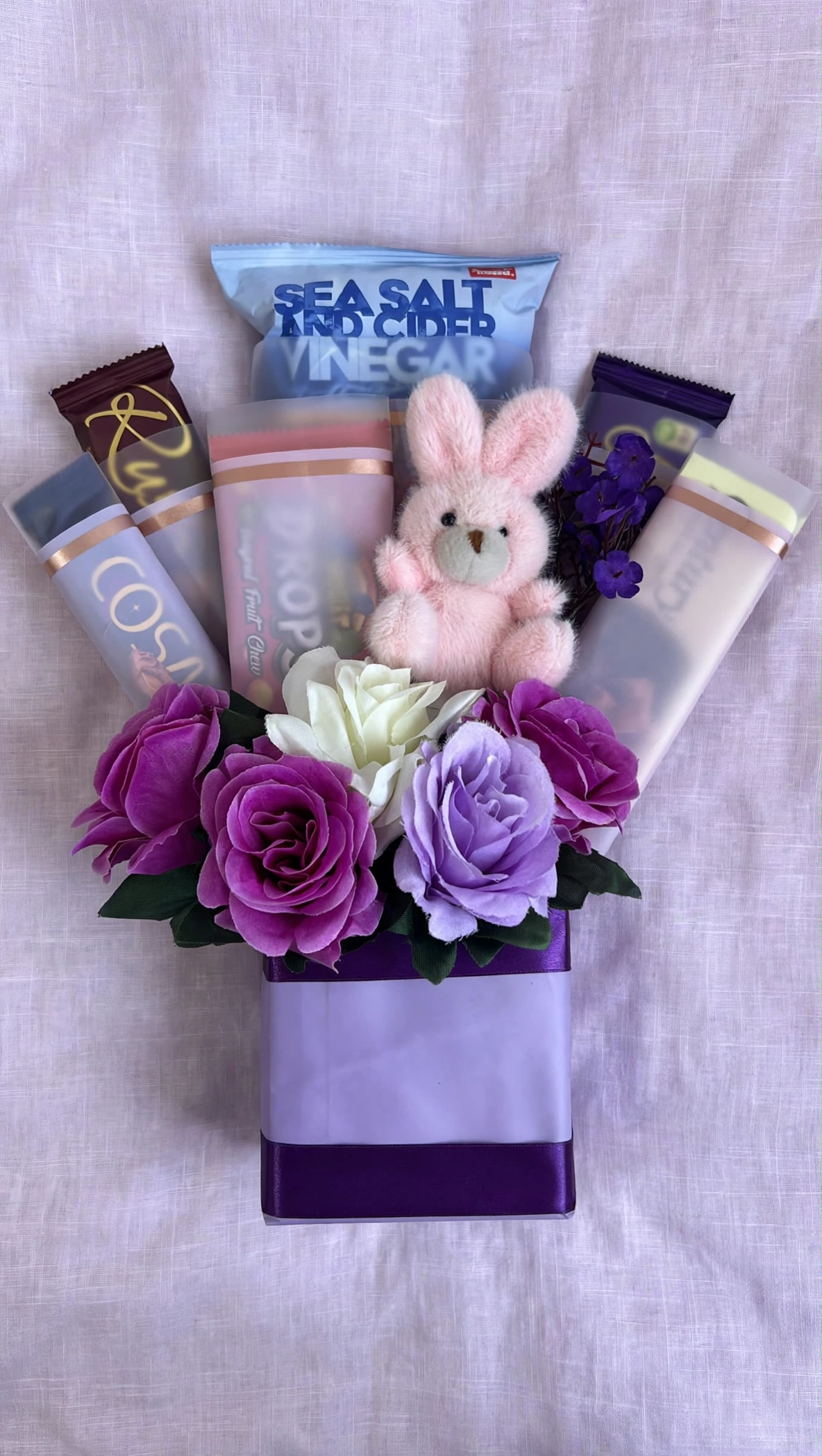 Lavender rose snack gift bag flat lay on lilac linen