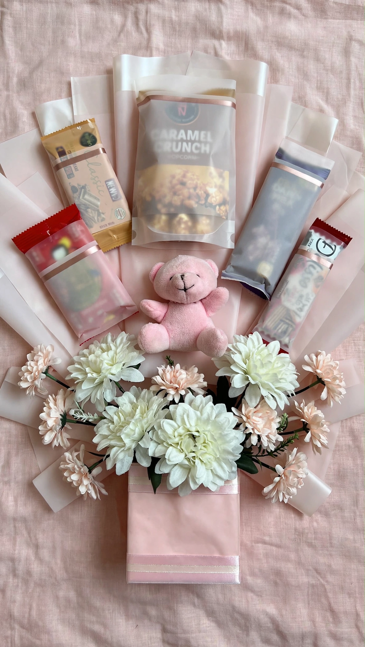 Blush snack gift bag flat lay on pink linen